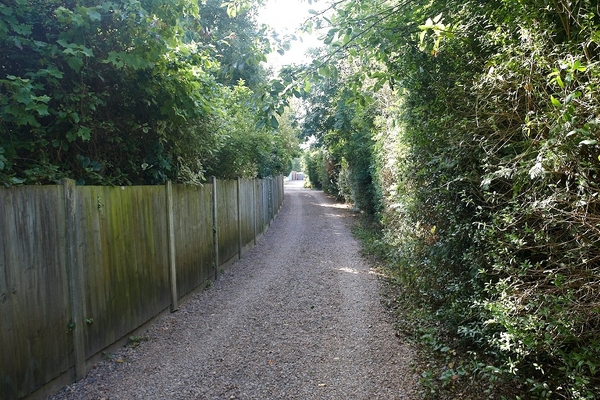 Walking Down Our Track
Taken from our track (and public footpath 578) looking south towards Colletts Green Road.  Our home is on the left, behind the wooden fence (east).  Jack and Margaret's home is on the right (west).  We have recently spread a new load of gravel on the track, thanks to the folks at Central Networks.  They'd just buried the power supply to our neighbours' homes beneath our track.
Keywords: track public footpath PW-578 Powick Worcester Colletts Green