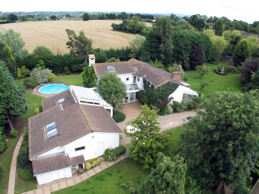 Whitecroft Viewed from the West
Photographed from the west, looking east.  The garage and indoor pool are in the foreground (double sky light over the indoor pool), exterior pool in the background.  The main house on the right.  This was photographed from our track.
Ključne besede: Whitecroft swimming pool garage track