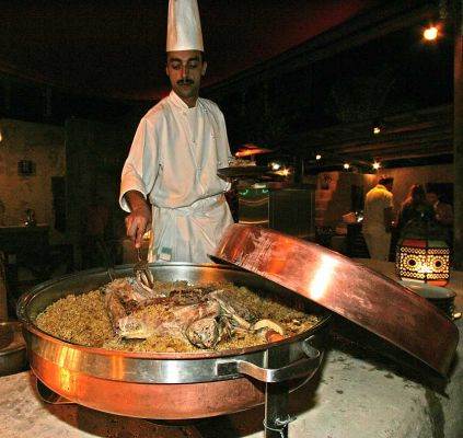 Lamb Cooking in the Desert
At the huge buffet in the desert restaurant at the Bab al Shams Hotel, there were many different types of lamb.  Here the chef is cooking a whole lamb with rice (minus, I think, the head).
Keywords: lamb Bab al Shams chef desert Dubai