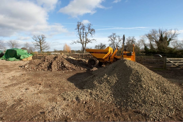 Pile of Scalpings and Hard Core
A day of rest.  Constructing a solid path to the wild boar field, and putting a dry (drained) hard standing beneath the pig arcs.
Keywords: Clay Construction Lucies Farm Maggot's Croft Mud Pigs