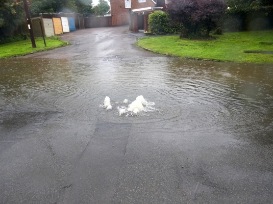 Sewage on Colletts Green Road
High rates, undersized sewers.  We have complained about this for years, but get the old "budget" story.  The sewers were probably fine until the housing estate was built.  No increased resources were put into the sewer, so the water bubbles up on Colletts Green Road, and then flows away into the River Severn through the run-off system.
Ключові слова: Colletts Green Road sewer flood Malvern Hills District Council Severn Trent Water