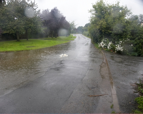 Looking Towards Bransford
Colletts Green Road, looking towards Bransford.  The water fountain in the middle of the road is the sewer.  It flows from the sewer into the highway drainage, and then down into the River Severn.  Fortunately the height of the road keeps it from coming onto our property.
Ключові слова: Whitecroft Colletts Green Road sewer rain flood water Severn Trent Water