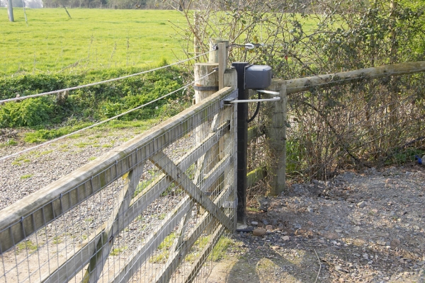 Stable Gate at Lucies Farm
Looking from the latch end towards the motor.  This motor, installed in early 2005 to replace an earlier motor, is mounted on a separate, metal gate post, and it opens and closes the gate (or at least it did, before it was broken by the windstorm) using the metal arm.
Keywords: stable gate automation gate gate motor