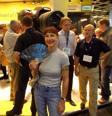 Craig wants THIS camera!
It was quite warm but not really warm enough for a fan but they were handing them out as you entered Photokina September 2006.  Craig saw this REALLY BIG camera and wanted it!
Keywords: Marjorie camera fan Photokina September 2006