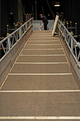 The Ramp at the Manchester Opera House
This was our first look at the large ramp built at the back of the stage of the Manchester Opera House for Ross' entrance and exit.   Jack Thompson is at the top of the ramp with the "Daisy Lifter" --- a sling to remove Ross from the theater if he just wouldn't walk up the ramp.  Of course, Ross was happy to use the ramp, so the "lifter" was not used.
Keywords: ramp Manchester Opera House Jack Thompson Daisy Lifter Ross of Bien Esk