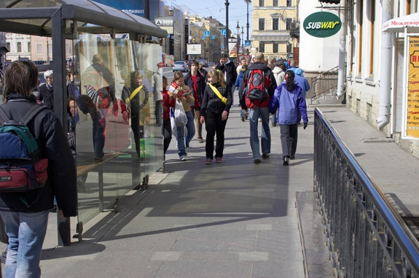 Nevsky Prospect - St. Petersburg
This is where my wallet was stolen.  This is one of the main streets in St. Petersburg, Russia.  Marjorie and I were walking up the street (same direction as the girl with the yellow shoulder bag) on a sunny spring afternoon.  A large man on a cell phone came out from behind the bus shelter (on the left in this photo) and blocked my path.  Others crowded me from behind when I stopped suddenly, and my wallet was gone.  The police didn't really care -- this is apparently typical in St. Petersburg.
Keywords: Nevsky Prospect theives pickpockets St Petersburg Russia
