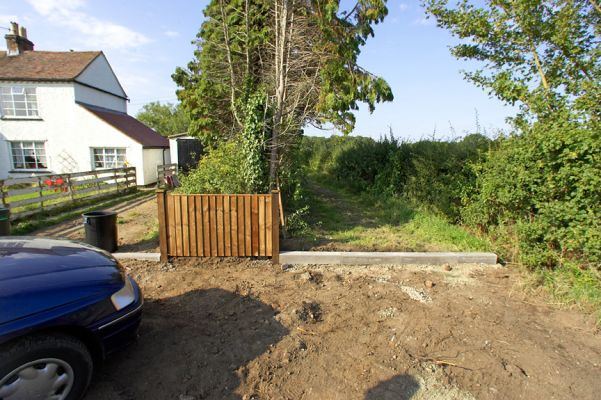 New Fence and Curb
By the afternoon of September 15 2006 (when this photo was taken) the new fence had been erected.  The curb across our track (the eastern track) is designed to retain the gravel we are about to install in the triangle between the fence and the road.
Ключови думи: Woodman's Cottage fence Thomas Hawkins Thomas Reeve Hawkins gravel Lord's Wood track