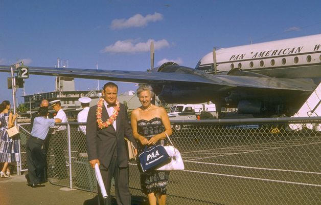 Honolulu Airport
I can only guess at the date of this photograph -- late 1950's or early 1960's.  The old Honolulu Airport terminal is behind the PanAm airplane.  I love the PanAm attendants doing things at the gate itself.  No air bridges.  My father with Nana:  not sure who's going where.
Klíčová slova: Nana John PanAm Pan American Airlines Honolulu Airport old terminal