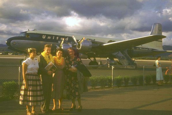 The Arrival -- Honolulu
My parents met at Leyland Powers, a school of theater and broadcast in Boston (long gone, I'd guess -- Google comes up with nothing).  They drove across country and then took a plane (shown) to meet my maternal grandparents in Hawaii.  On the way, they got married in Nevada.  This photo shows Birdie (my aunt),  my father, mother, and grandmoter at Honolulu Airport, summer 1948.  I can imagine it was an interesting arrival.
Keywords: United Airlines Leland Powers School Boston Birdie Nana Honolulu Airport Shirley John