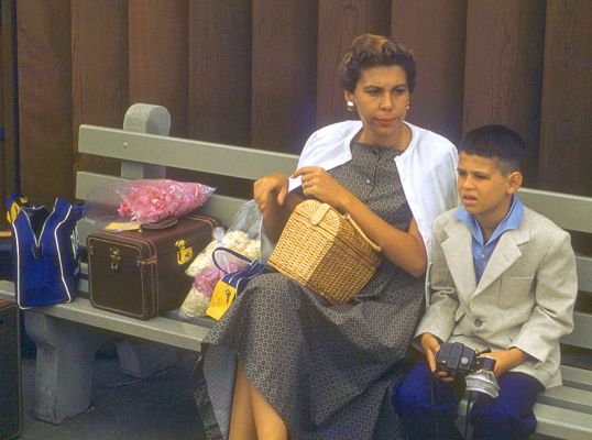 Mother Looking Pleased
I think this was taken at Honolulu Airport.  Note the luggage and my little travelling blazer:  in those days we dressed up to take an airplane somewhere.  I was already taking photographs:  note the camera.  I'd obviously done something to make my mother happy, since she has such a Happy Face.  Not!
Anahtar kelimeler: Shirley Honolulu Airport brownie camera Craig