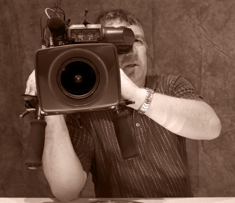 Chris Hartley -- Camera to Camera
[url=http://www.imdb.com/name/nm0366810/]Chris[/url] was filming me taking pictures.  So I clicked away as he filmed me.  A camera-to-camera shoot-off.
Keywords: Chris Hartley Cinematography Impress Me Lens Photography RDF Video Camera
