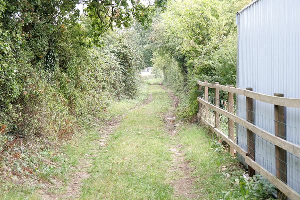 Looking Southward Down The Track
Lord's Wood Cottage (with its new extension) is on the right.  This photograph shows how the tyre tracks have moved to the east (left in this photograph) because the post-and-rail fence is too far to the east.
Keywords: Lord's Wood Cottage post and rail Thomas Hawkins fence