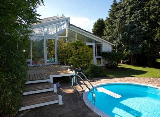 Whitecroft Orchid House and Gym
Artur is working on sanding and re-staining the back deck by the swimming pool.  The Skamper Ramp (emergency exit for dogs, should one fall into the pool) seems to be floating in the blue water.
Keywords: Whitecroft Orchid House swimming pool gym blue sky blue skies deck decking