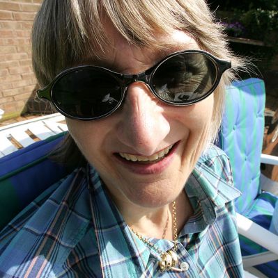 Cathy In Sunglasses
It's a Bank Holiday week-end, and yet it's sunny?  I have a new wide angle lens and I've been experimenting.  The lens allows me to get quite close -- but it does strange things to your nose!  Whitecroft, April 30 2005
Keywords: Cathy summer wide angle lens Whitecroft garden nose